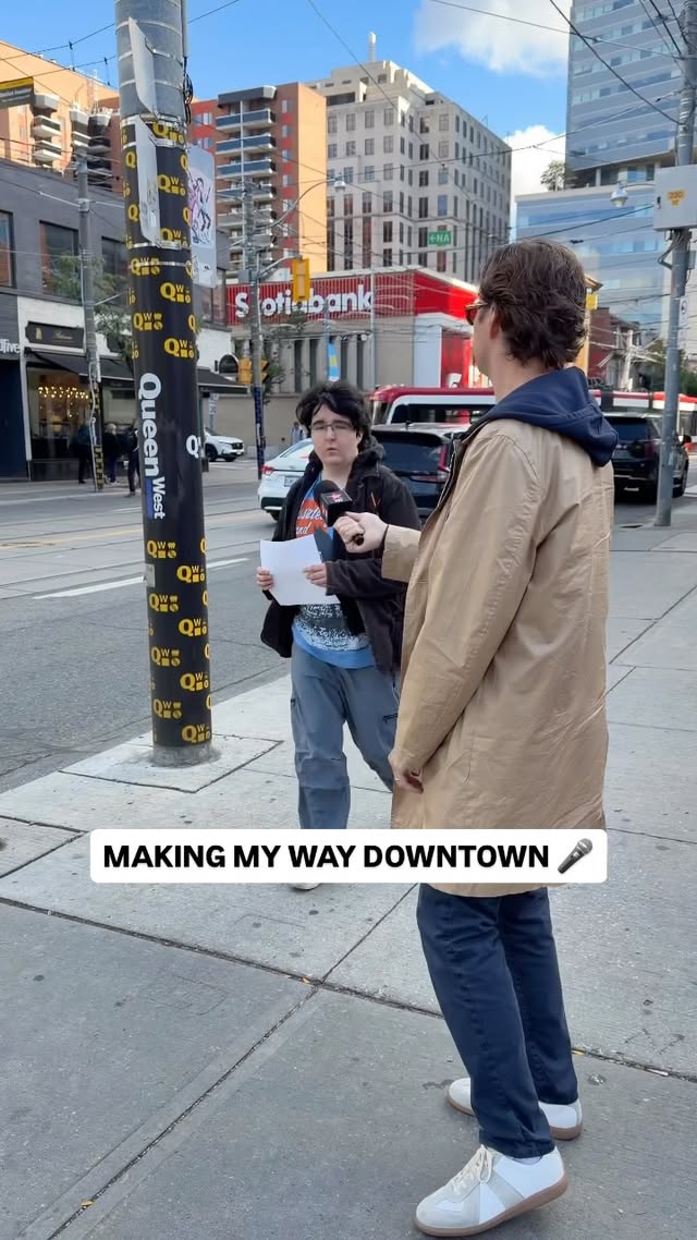 Myles interviews a passerby on a Toronto sidewalk